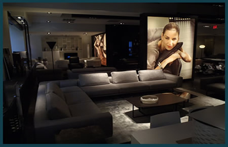 Showroom with built in lighted walls and custom graphics floating in middle of display and dramatic ceiling overlay.