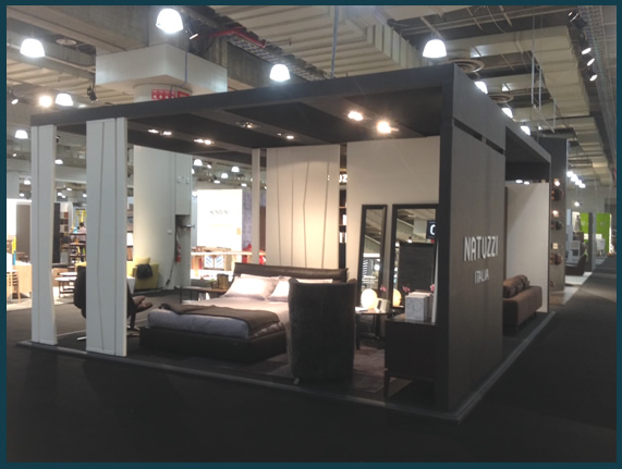 Another view of the Natuzzi Italia floating showroom in a large building with multiple vendors.